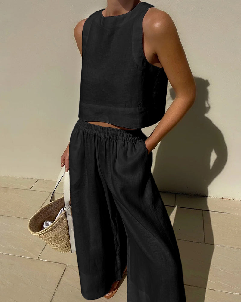 Todelt sæt til damer med ærmeløs cropped top og bukser med brede ben